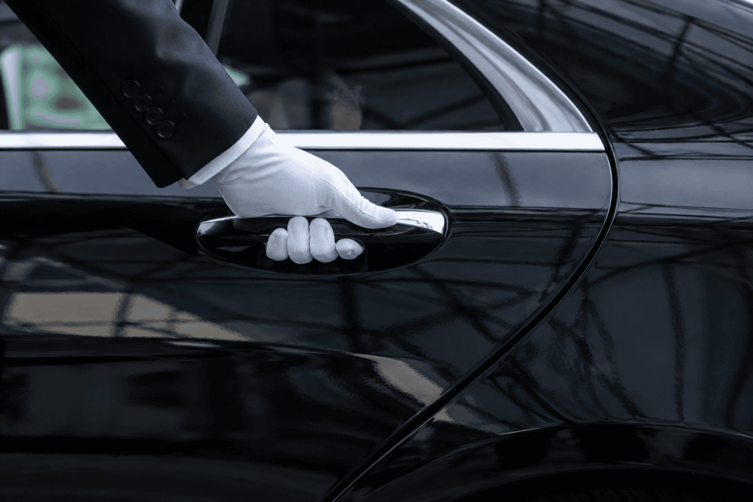 White-gloved chauffeur opening the door of a black Mercedes for a VIP airport transfer in Helsinki